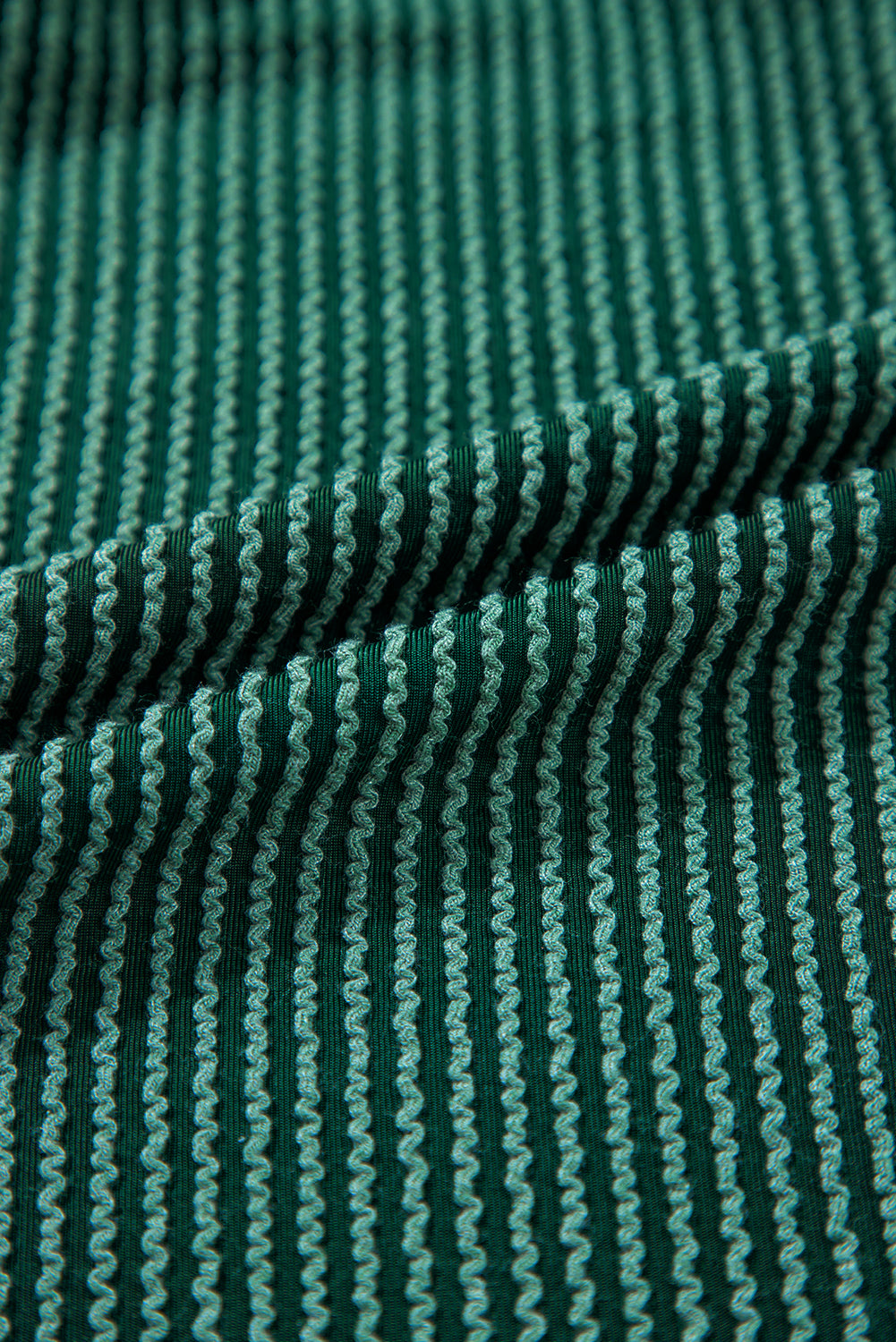 Close-up of green ribbed corded fabric from Evergreen JOLLY Set. Soft texture ideal for fall and holiday wear from Faith & Co. Boutique.