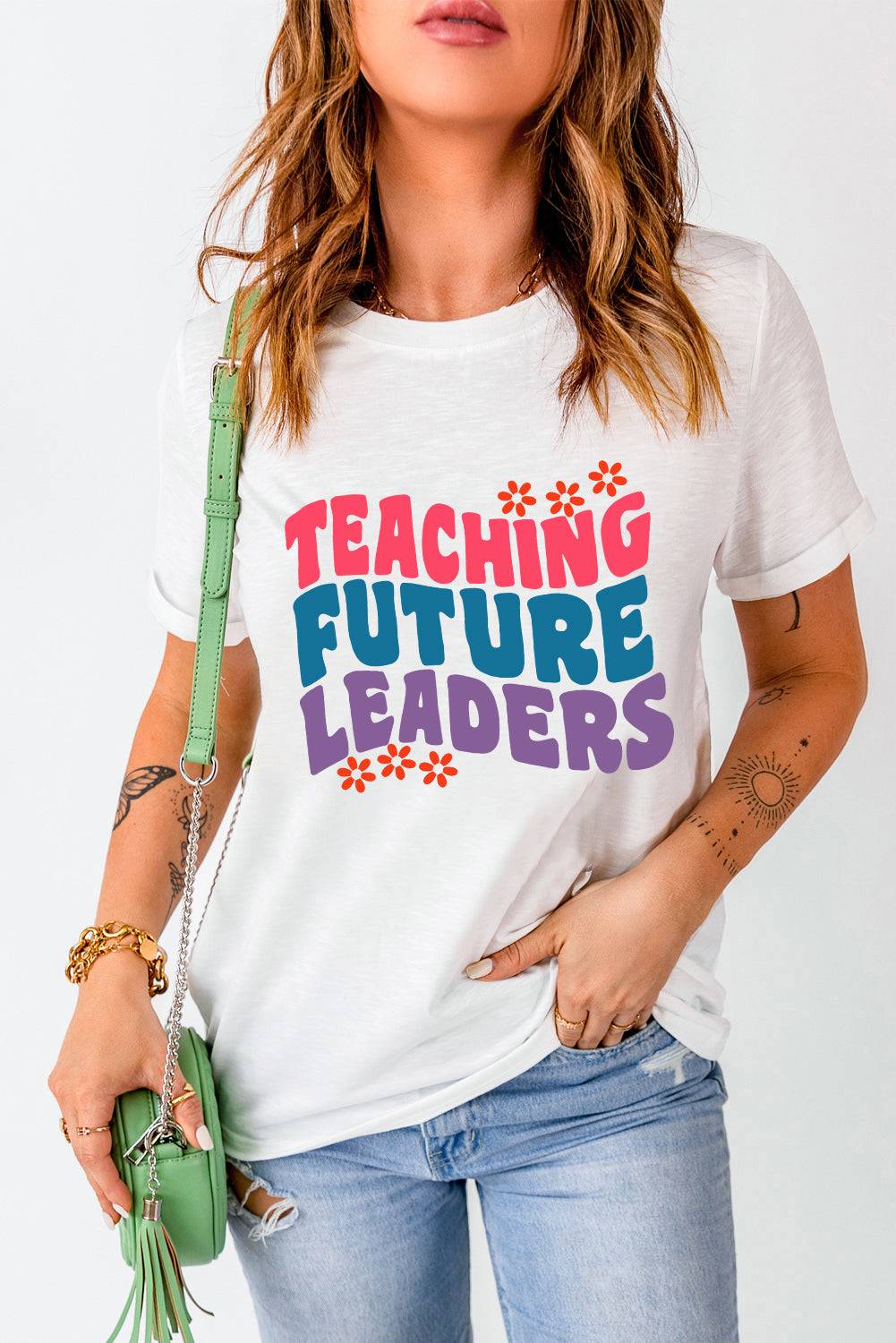 a woman wearing a t - shirt that says teaching future leaders