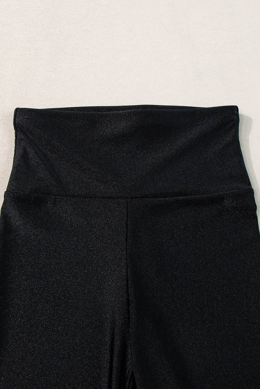 a close up of a person's black pants