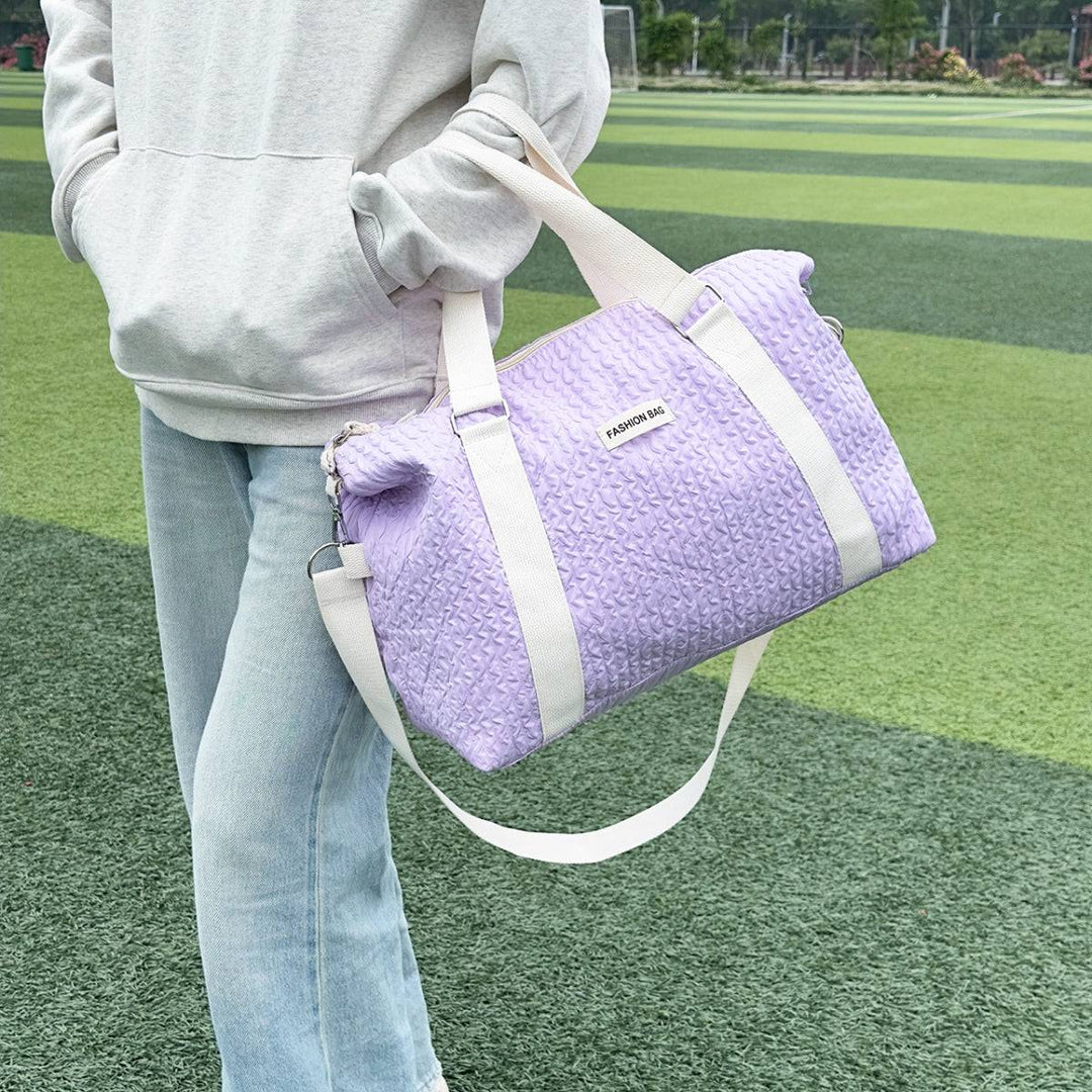 a person holding a purple bag on a field