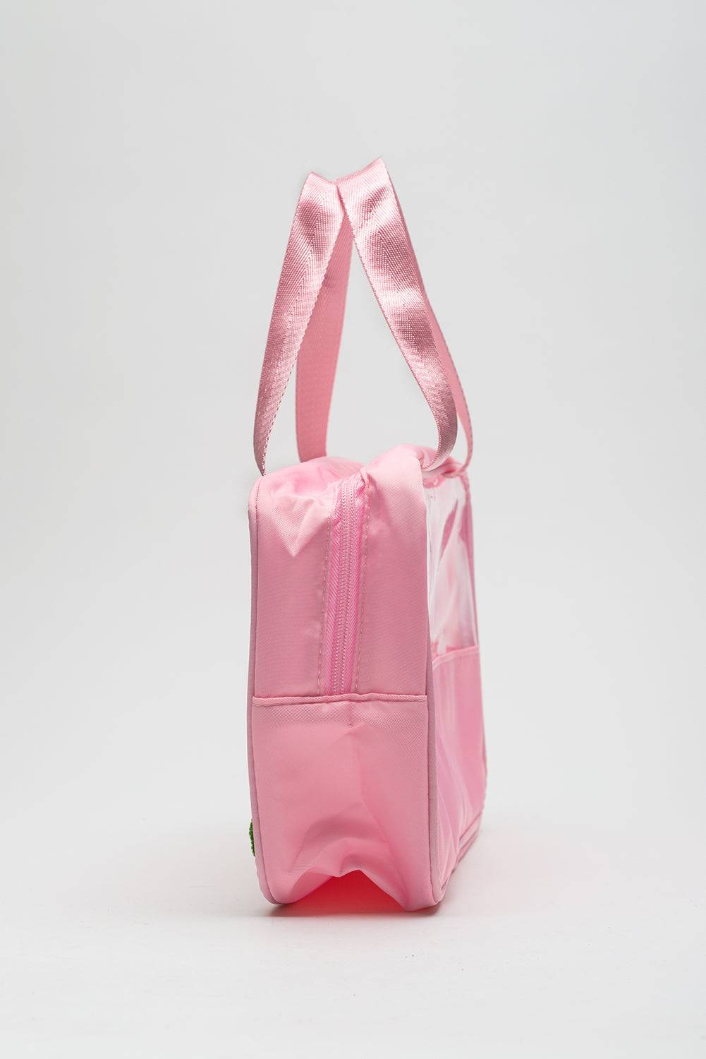 a pink lunch bag with a pink strap