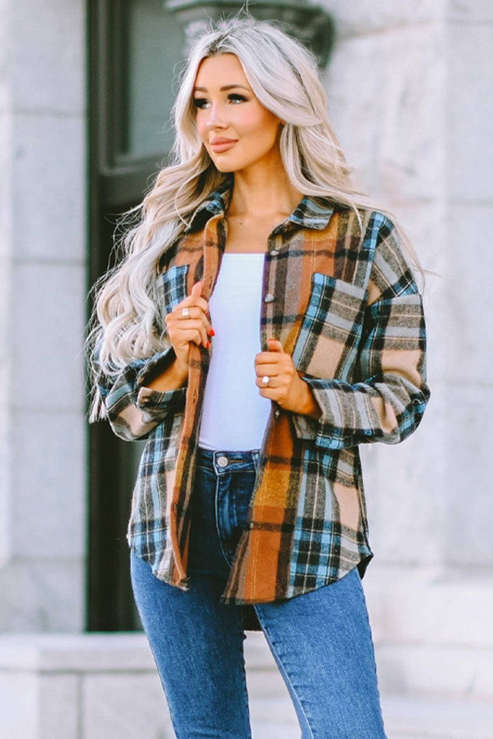 a woman wearing a plaid jacket and jeans