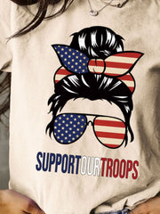 a woman wearing a t - shirt that says support our troops