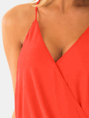 a close up of a woman wearing a red top