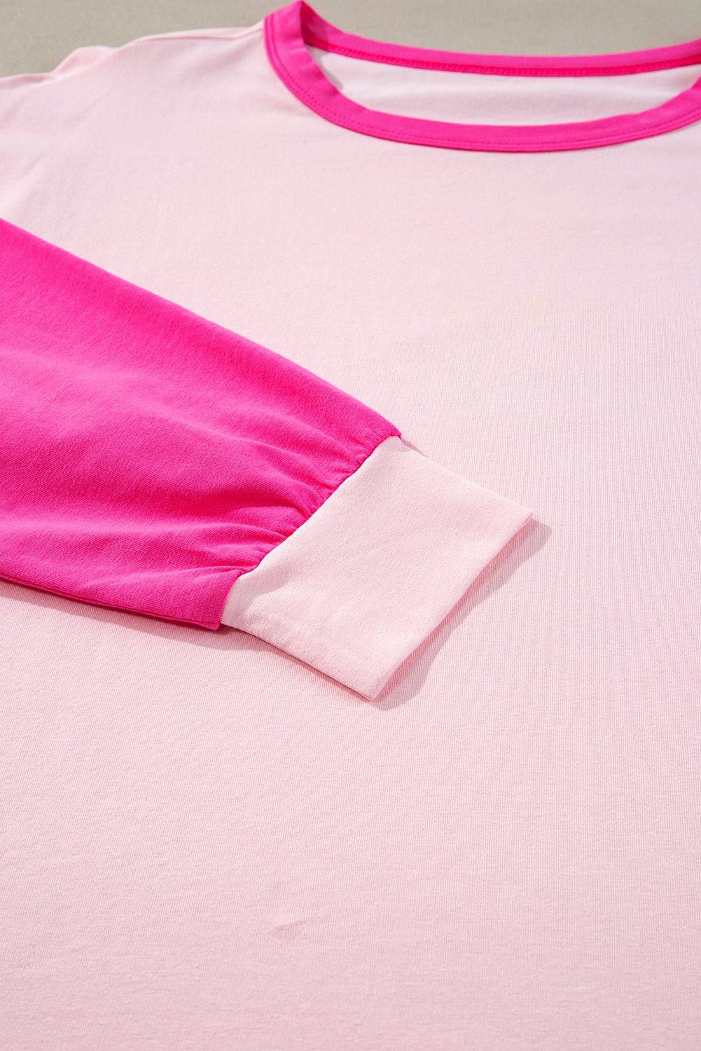 a close up of a pink and white shirt