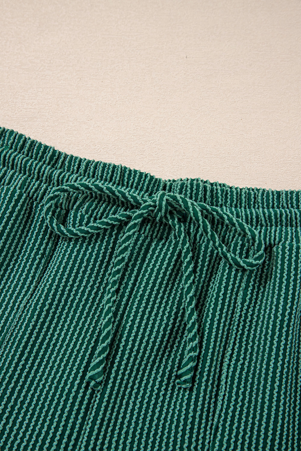 Drawstring waistband detail of green Evergreen JOLLY Corded Pants. Adjustable fit for comfort from Faith & Co. Boutique.