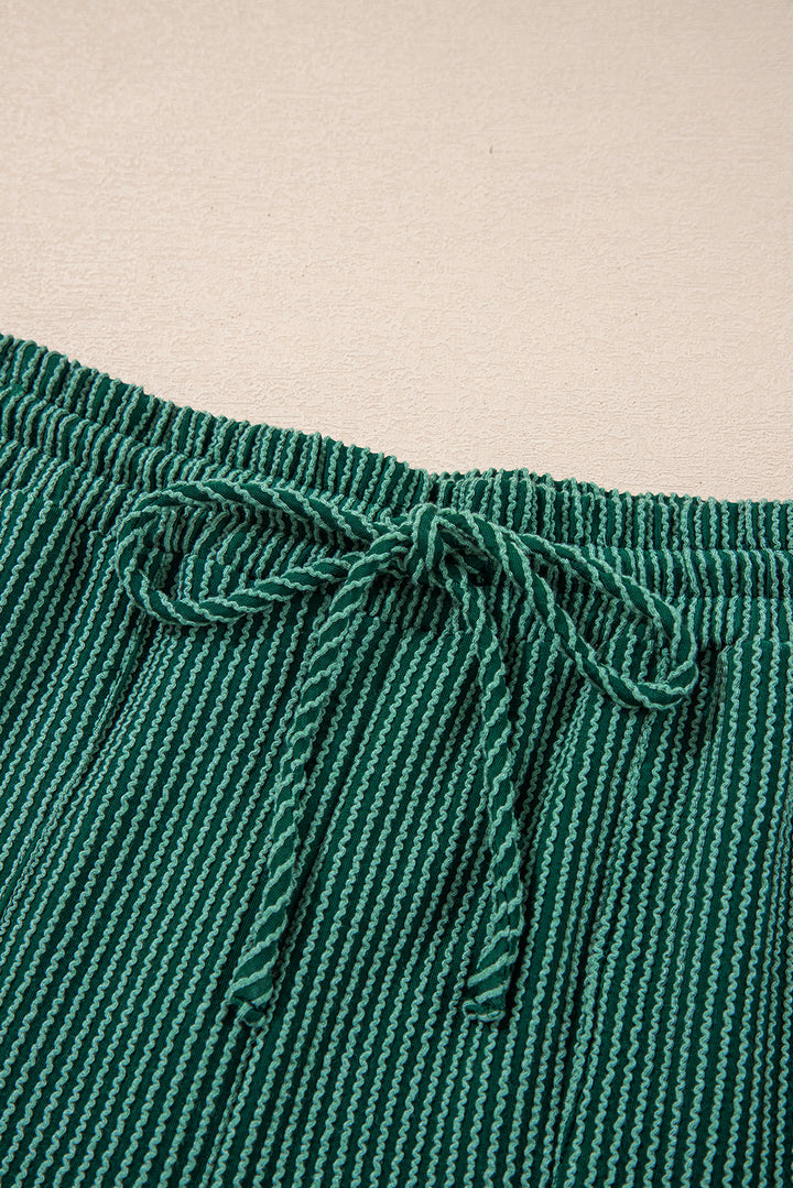 Drawstring waistband detail of green Evergreen JOLLY Corded Pants. Adjustable fit for comfort from Faith & Co. Boutique.