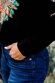 a close up of a person wearing a black shirt and jeans