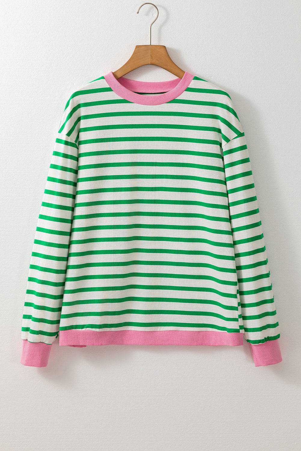 a green and white striped shirt hanging on a hanger