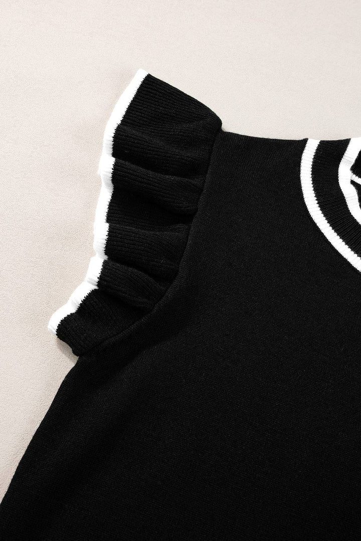 a close up of a black sweater with white trim