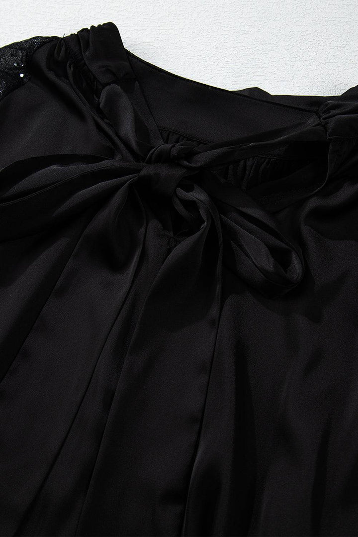 a close up of a black dress with a bow