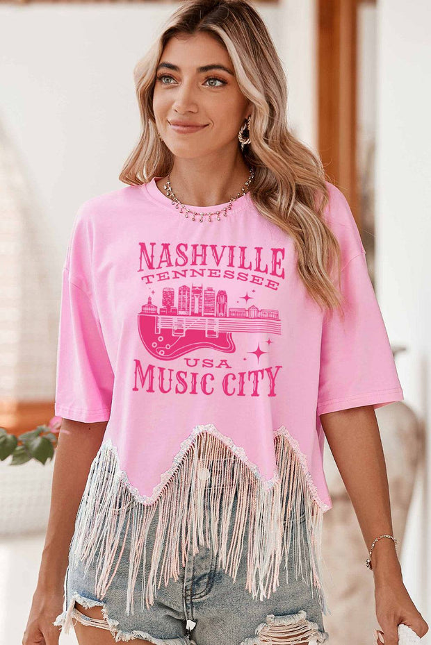 a woman wearing a pink nashville music city shirt
