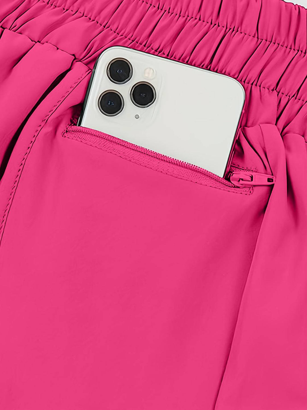 a cell phone sticking out of the pocket of a pair of pink pants