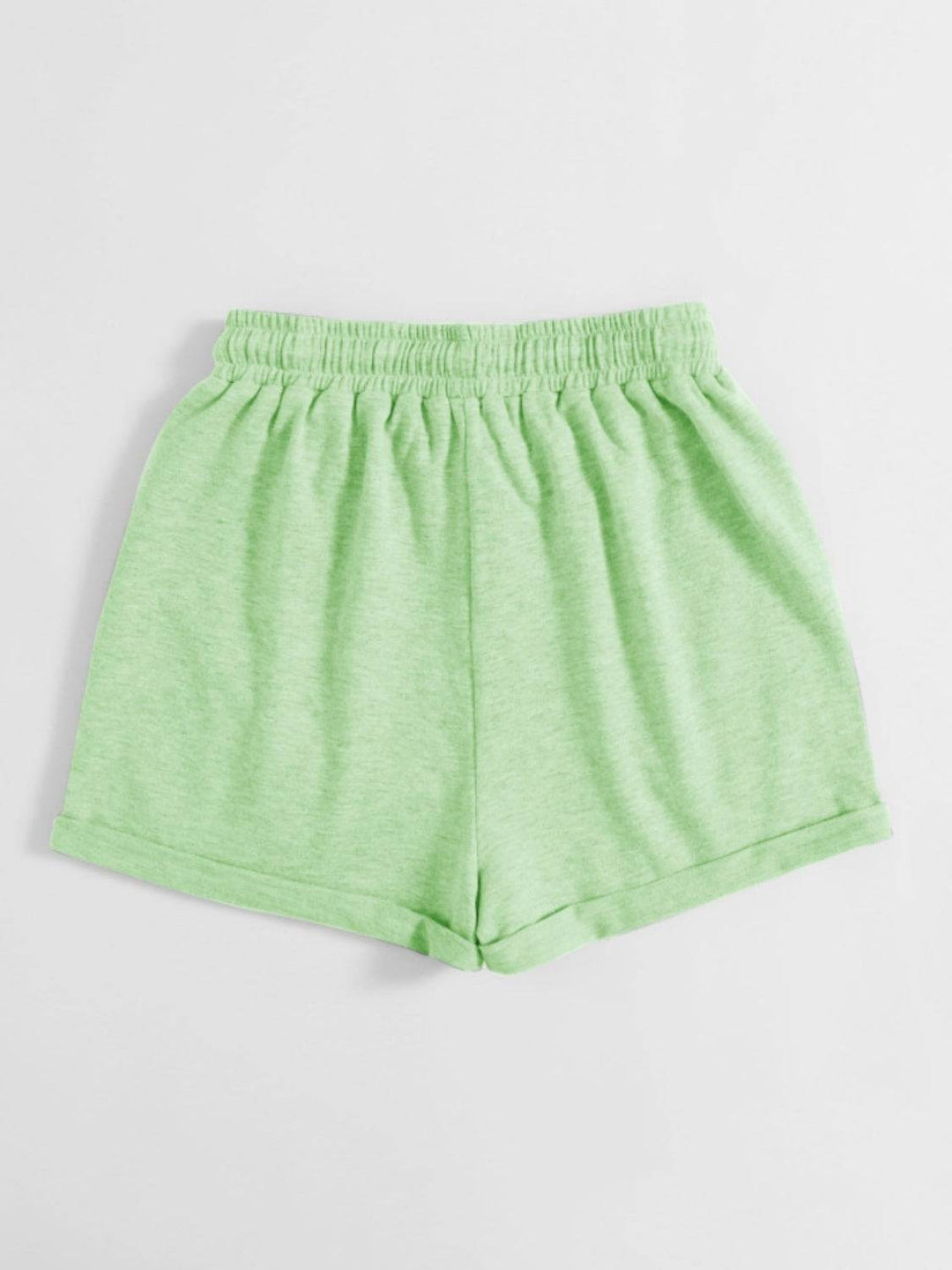 a pair of green shorts on a white background