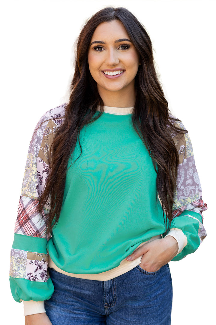 Isolated product view of Aruba Blue Plaid Vintage Paisley Patchwork Long Sleeve Raglan Top on white background. Available at Faith & Co. Boutique.