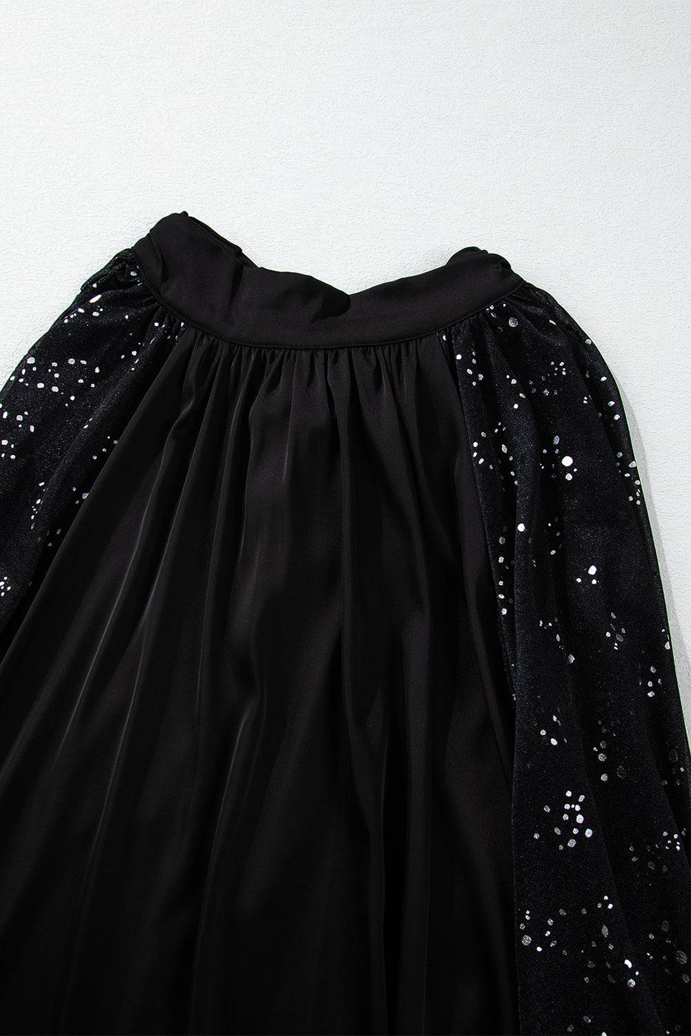 a black dress with silver sequins on it