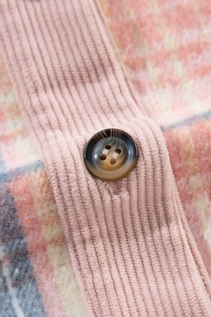 a button that is on a pink sweater