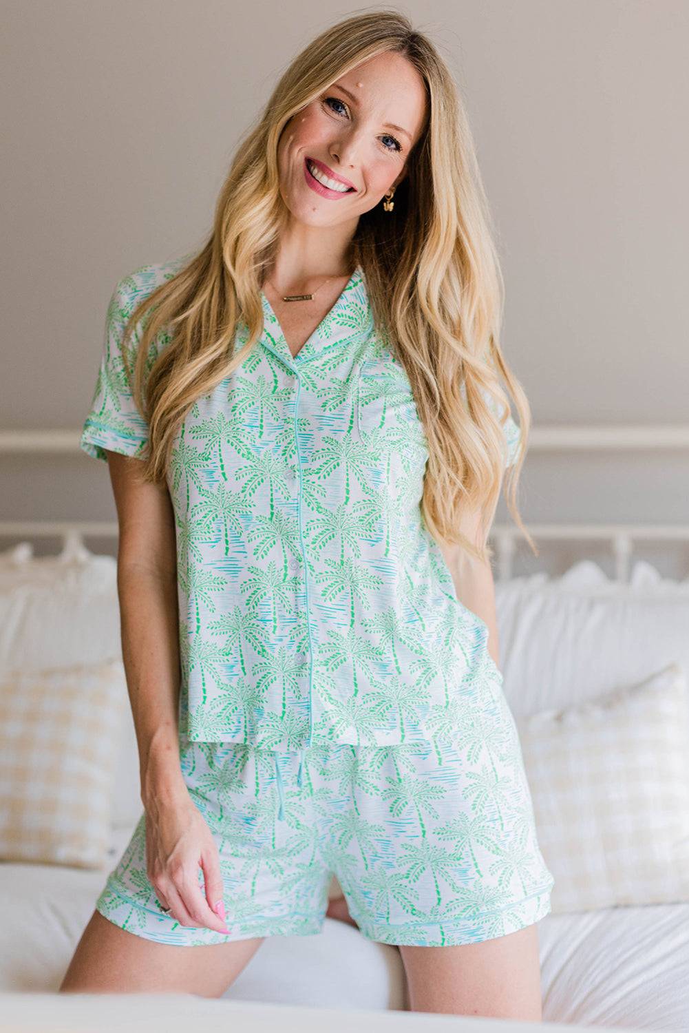 a woman in a short pajama set posing on a bed