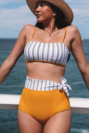 a woman in a yellow bikini and hat