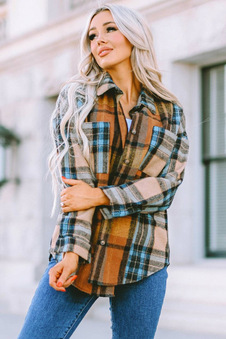 a woman wearing a plaid shirt and jeans