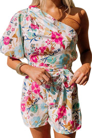 a woman in a floral print rom and shorts