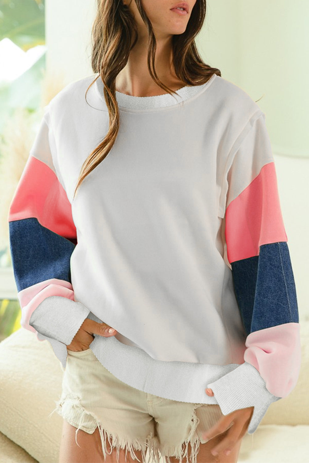 Front view of White French Terry Color Block Long Sleeve Top featuring bold sleeve accents in pink and denim blue. Available at Faith & Co. Boutique.