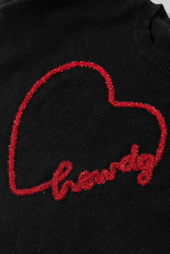 a black sweatshirt with a red heart embroidered on the chest