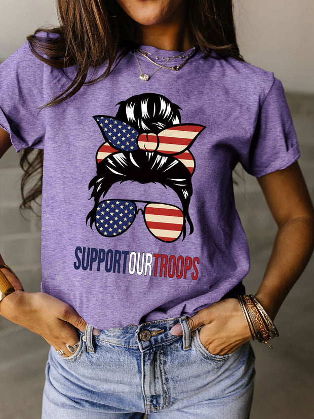 a woman wearing a purple shirt that says support our troops