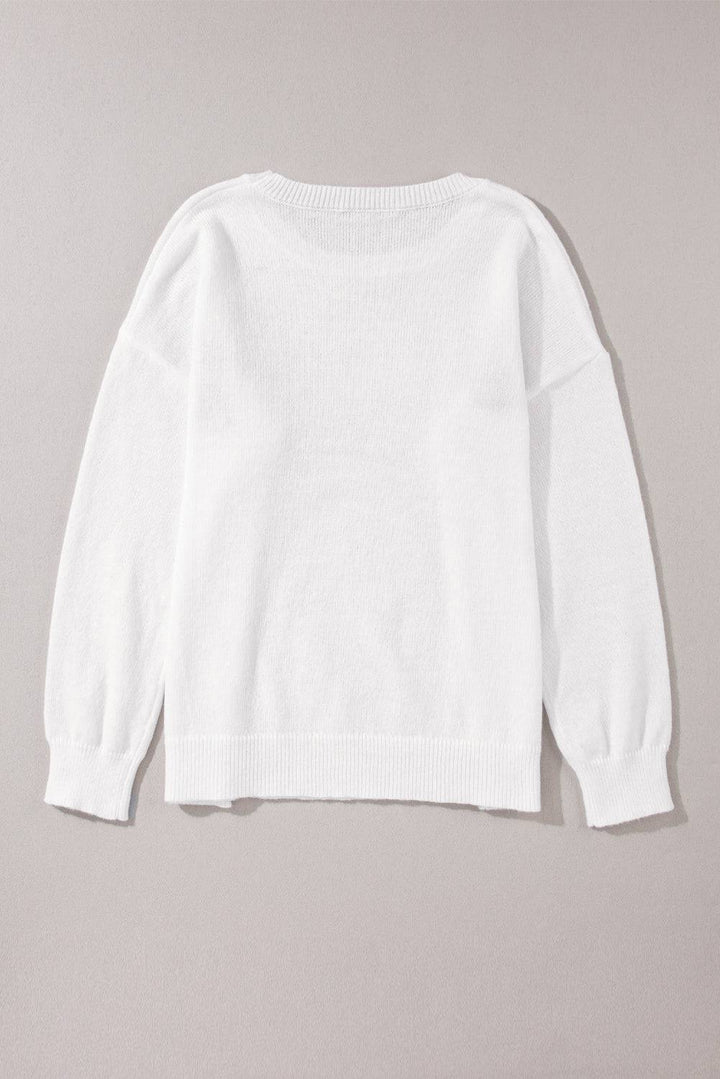 a white sweater hanging on a wall