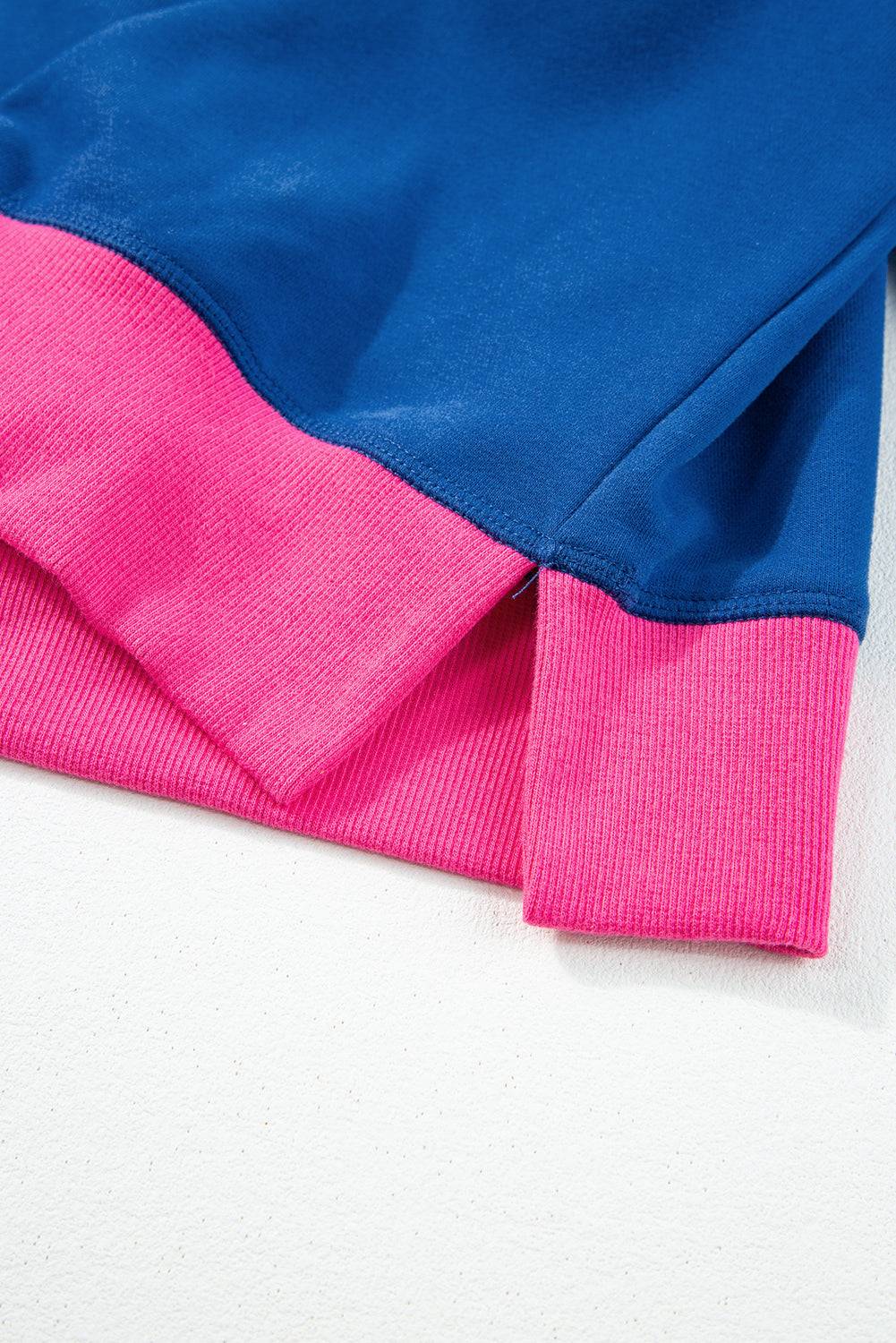 a blue and pink shirt laying on a white surface