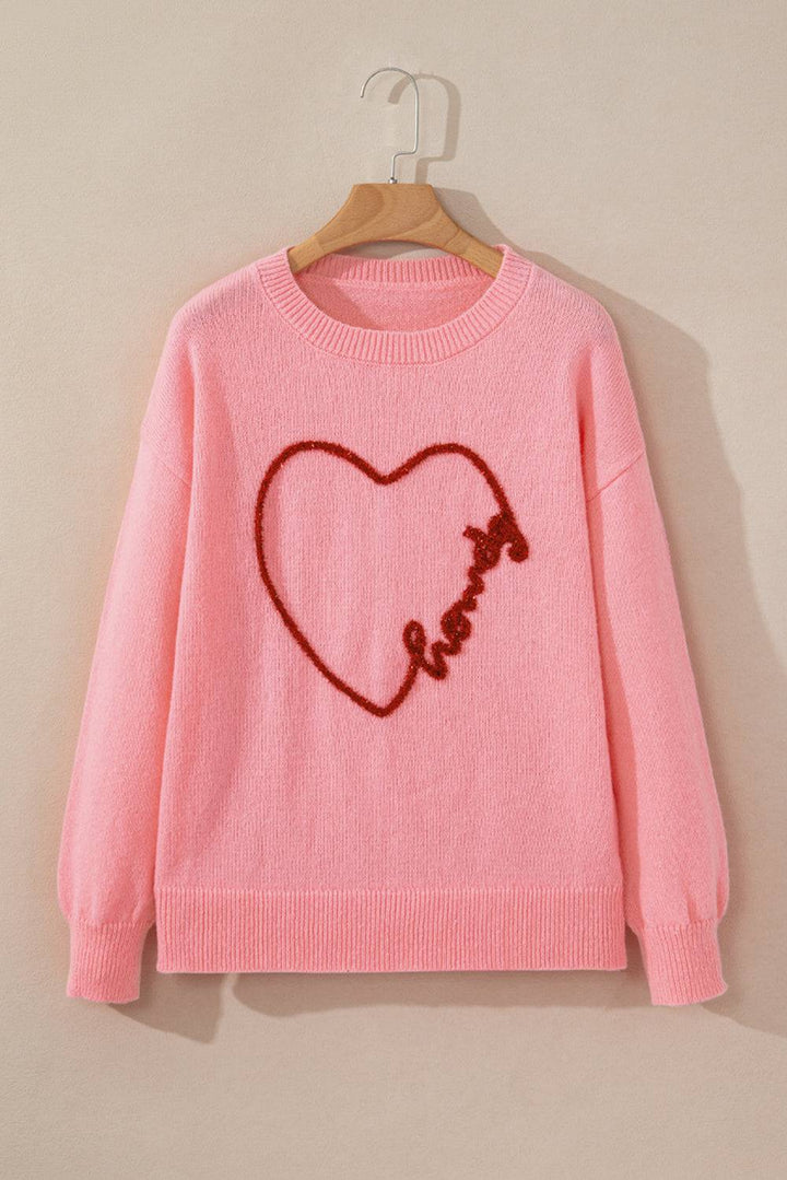 a pink sweater with a heart drawn on it