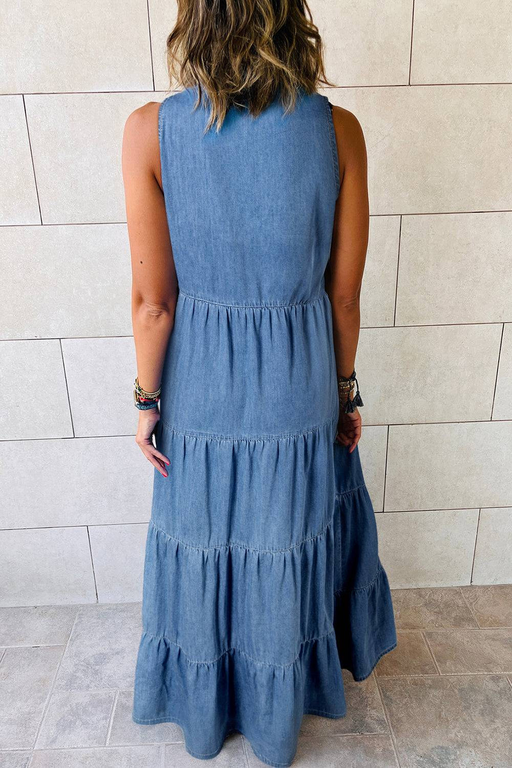 a woman in a blue dress standing in front of a wall