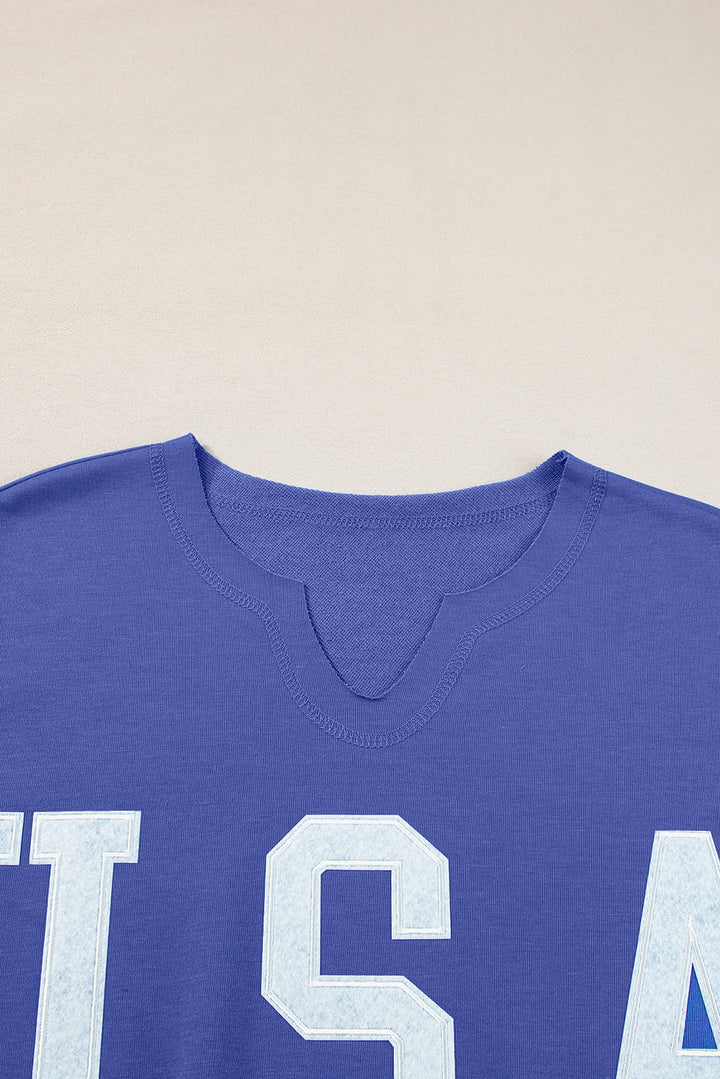 a close up of a blue ts shirt with white letters