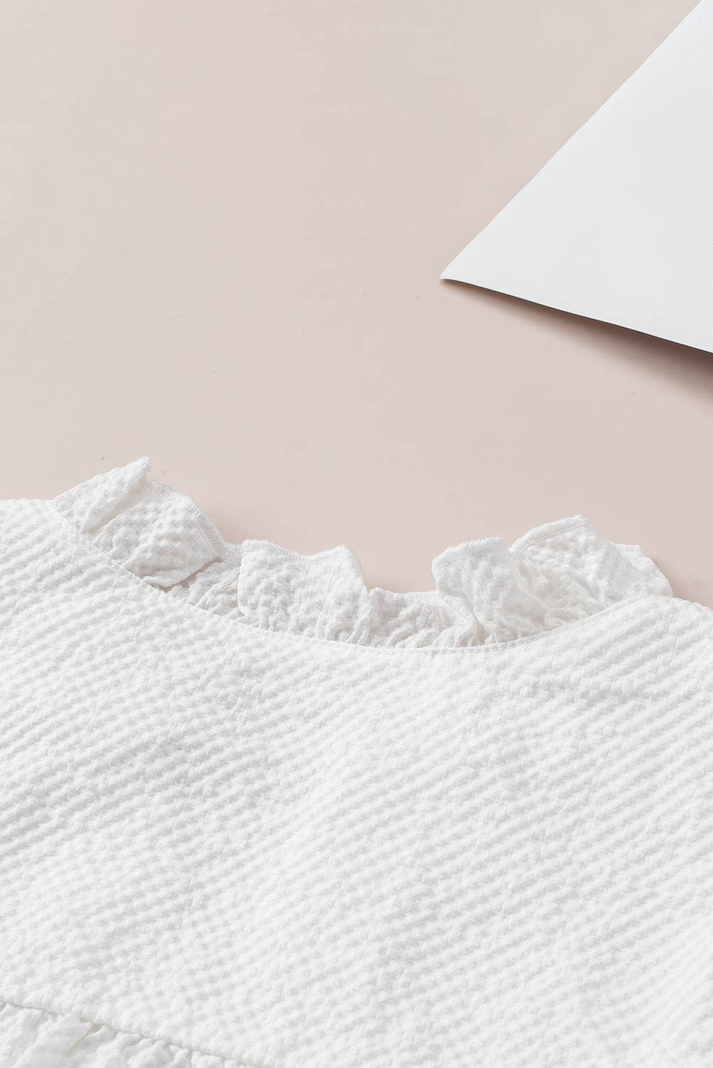 a close up of a white dress on a table