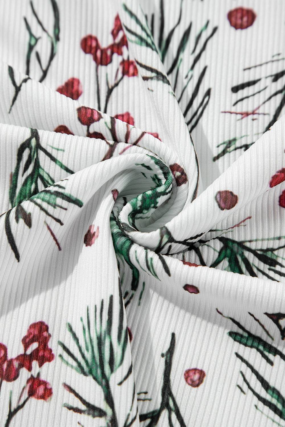 a white fabric with red and green flowers on it