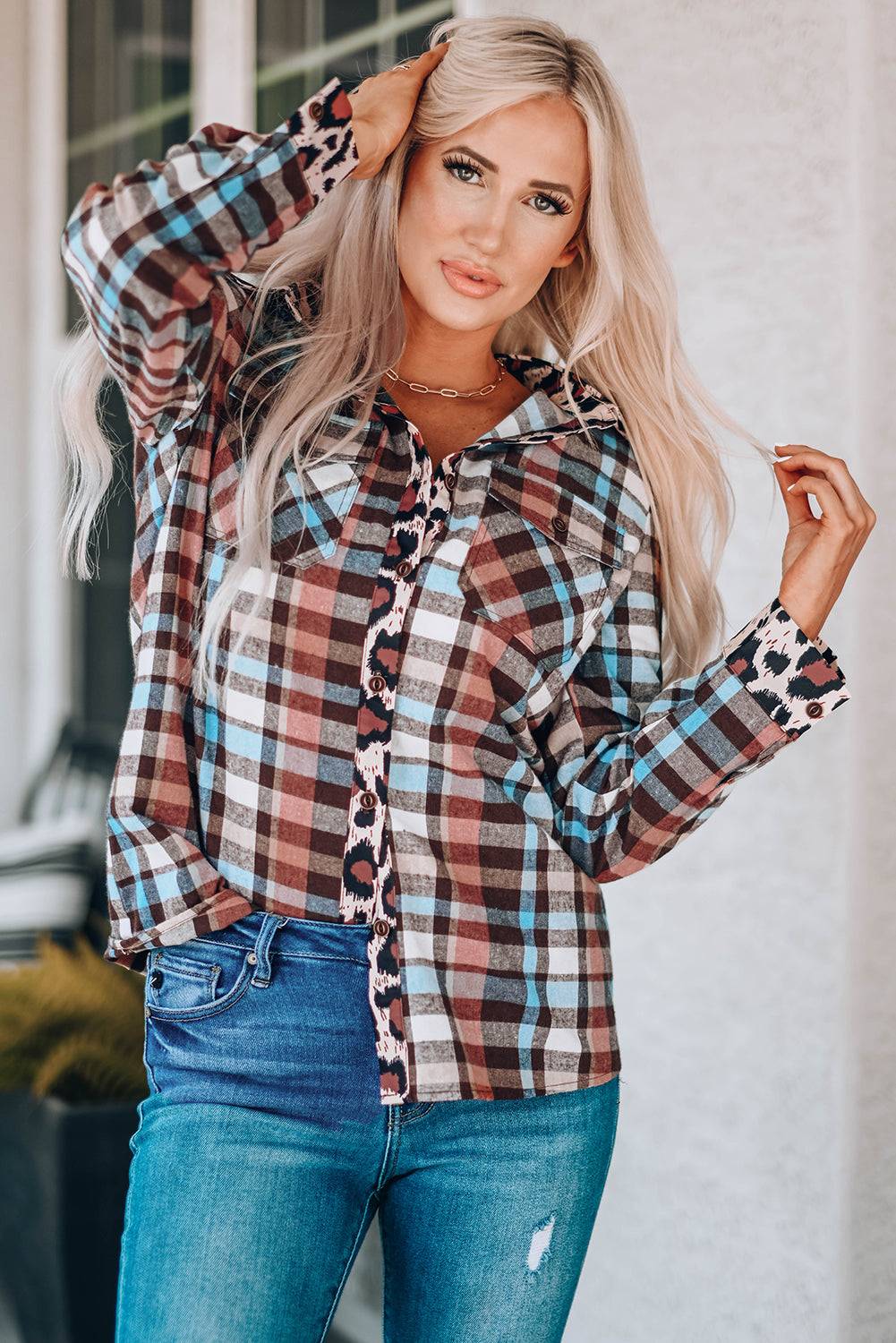 a woman posing for a picture wearing a plaid shirt