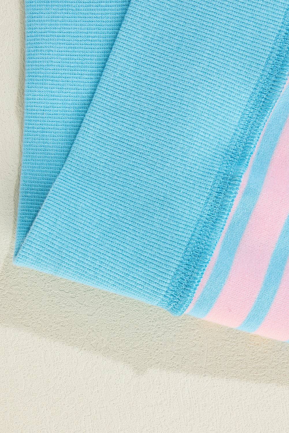 a blue and pink towel laying on top of a white surface