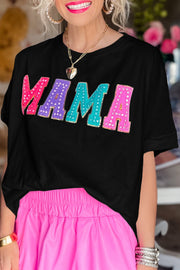 a woman with blonde hair wearing a black shirt and pink skirt