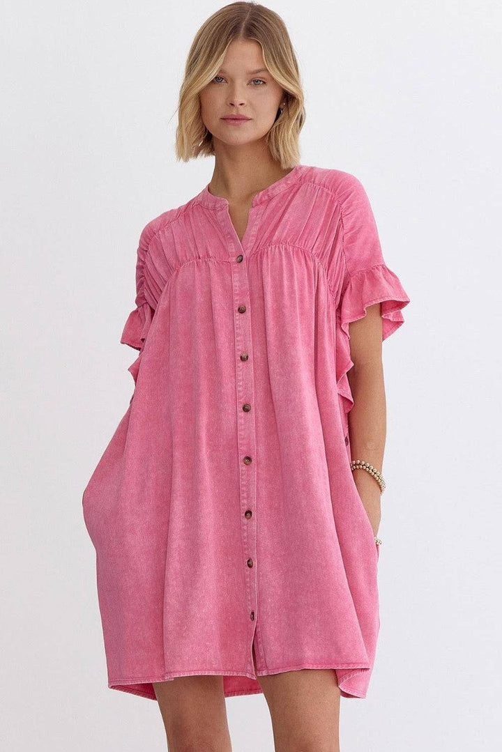 a woman in a pink shirt dress