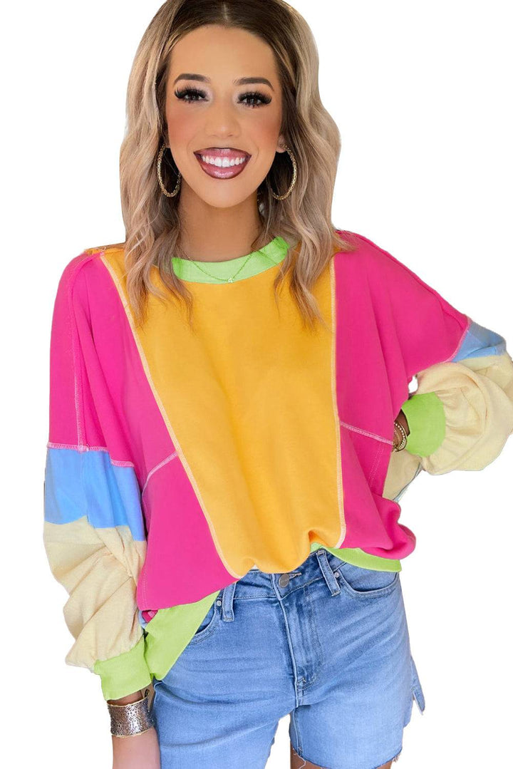 a woman with blonde hair wearing a colorful top
