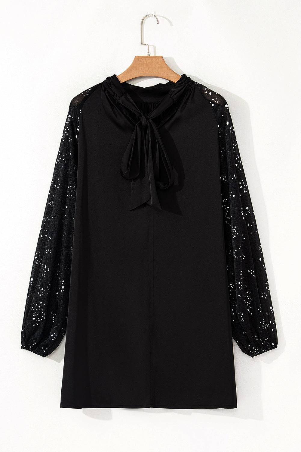 a black blouse with a bow on the neck