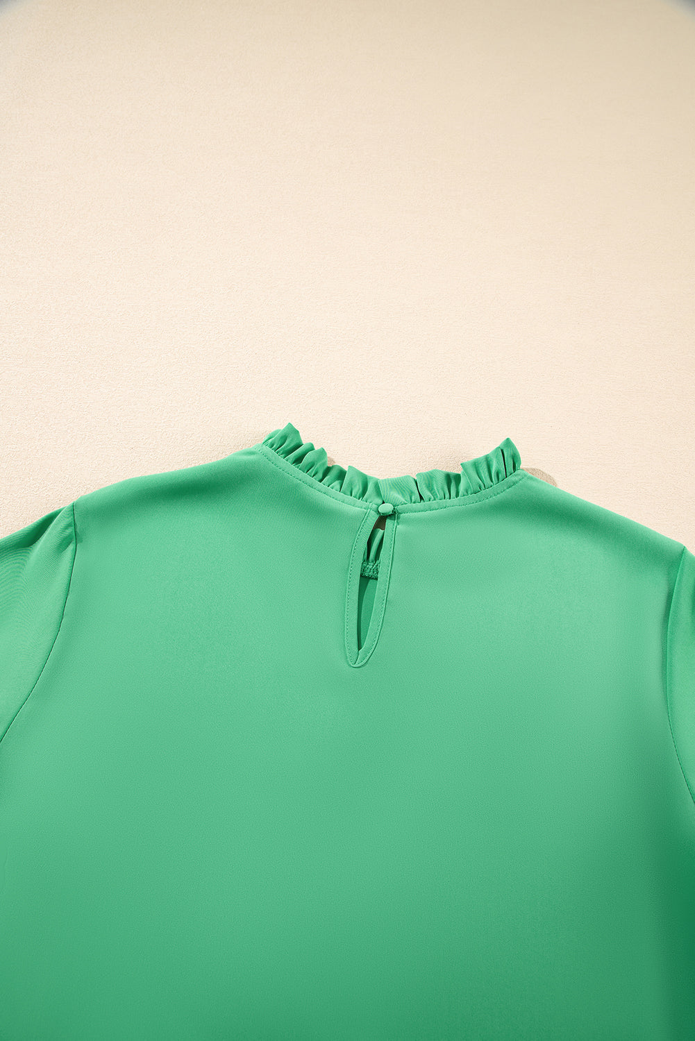 Back neckline detail of Green Frilly Round Neck Wide Half Sleeve Blouse with button closure, perfect for daily summer wear.