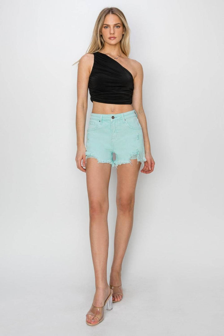 a woman in a black top and light blue shorts