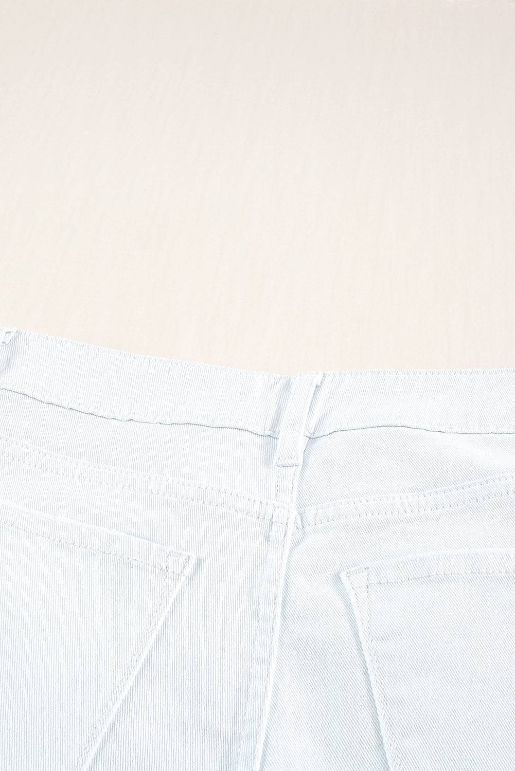 a close up of a pair of white jeans