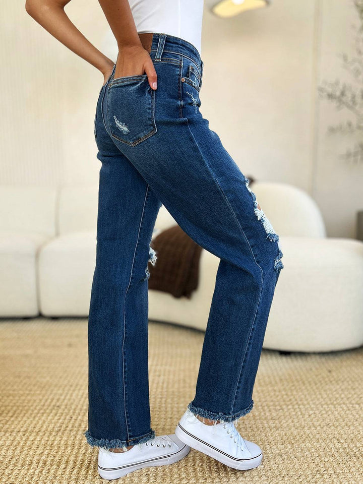 a woman in white shirt and jeans standing in a room