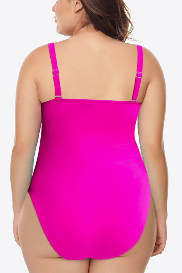 a woman in a pink one piece swimsuit