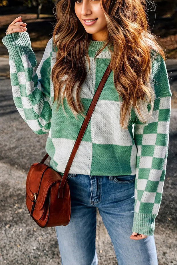 a woman wearing a green and white checkered sweater