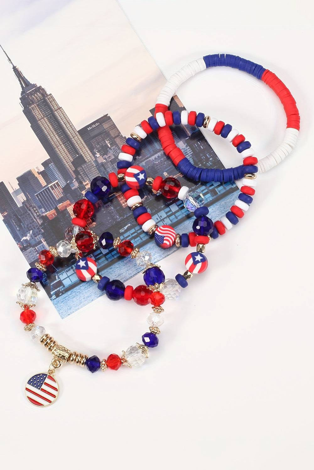 a red, white, and blue beaded bracelet with an american flag charm