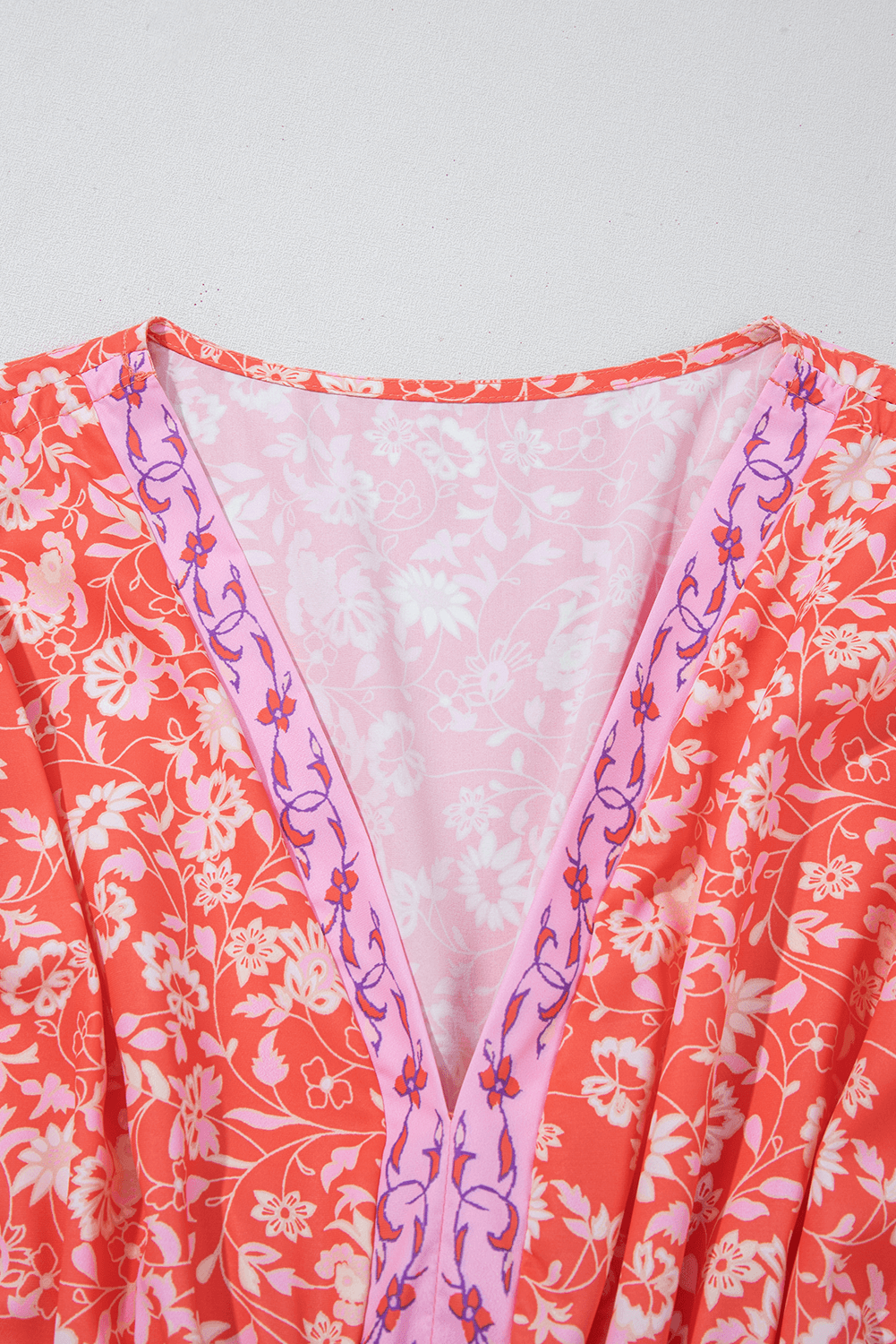 close-up of V-neckline with floral embroidery on Red Floral Print Tasseled Tied Sleeve Empire Waist Maxi Dress, adding feminine detail