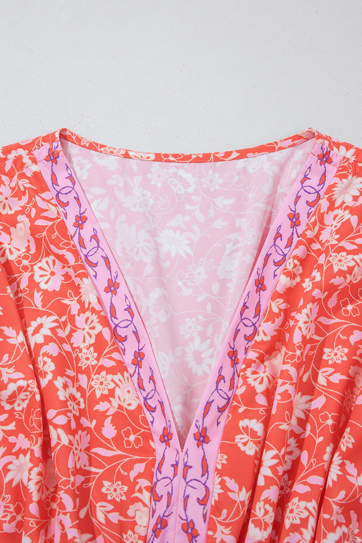 close-up of V-neckline with floral embroidery on Red Floral Print Tasseled Tied Sleeve Empire Waist Maxi Dress, adding feminine detail